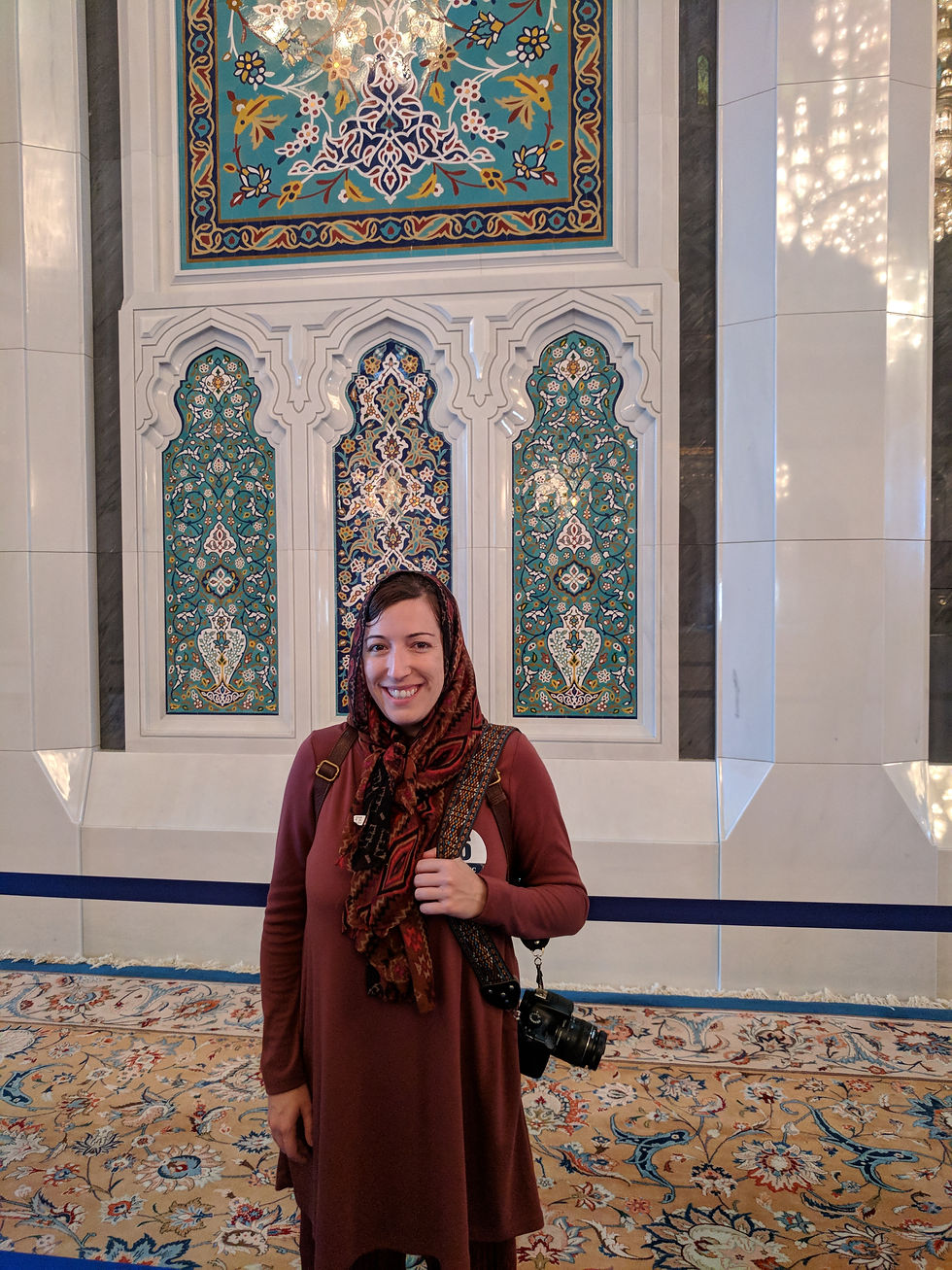 woman inside a colorful tiled mosque