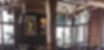 Industrial chic restaurant space with art nouveau paintings on the wall