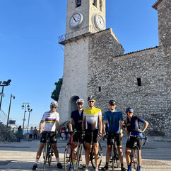Cyclists on the background of Church of Notre Dame d'Esperance on Suquet Hill