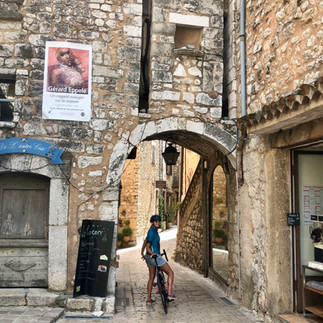 St-Paul de Vence and She's a Cyclist posing on the Old Town Entrance Arch