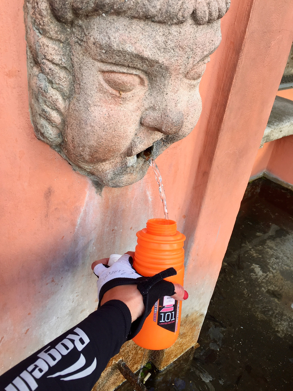 Aleks filling her water bottle at the local fountain