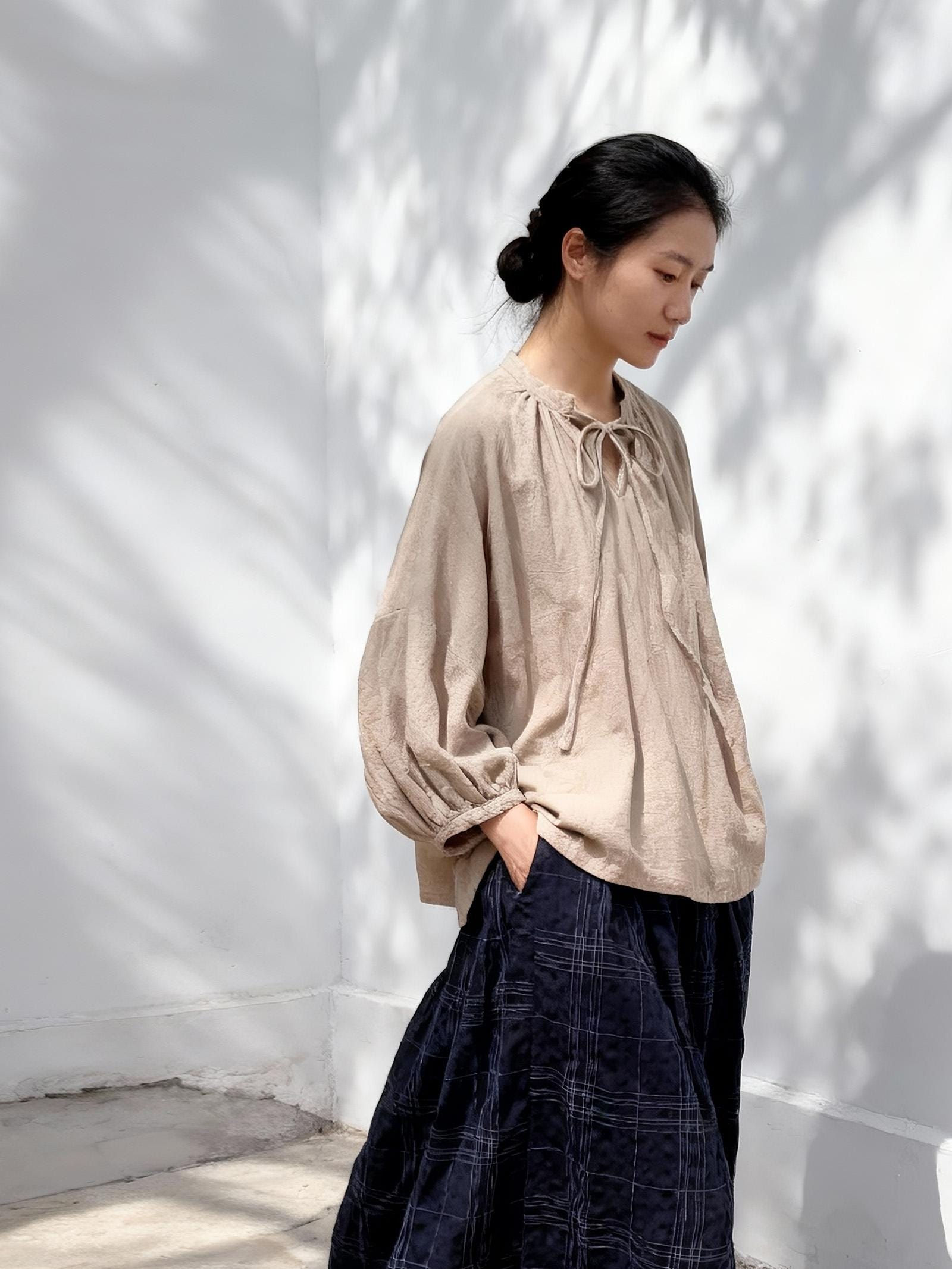 Graphite grey linen cotton gathered tie-neck blouse in oversized loose fit on model