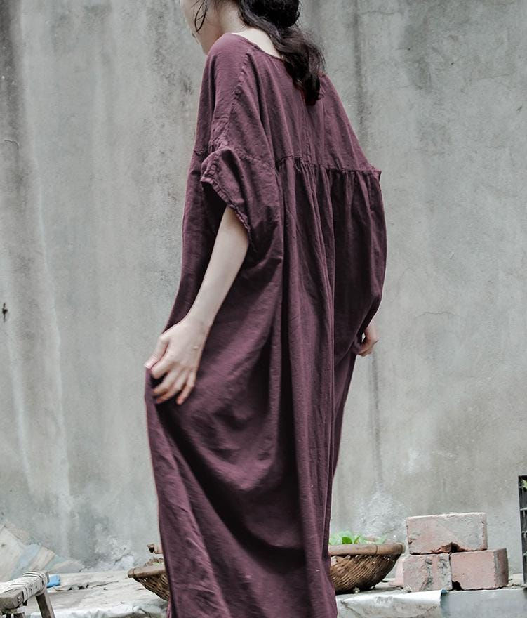Loose fit linen cotton maxi dress showing dropped shoulder and wide sleeve detail