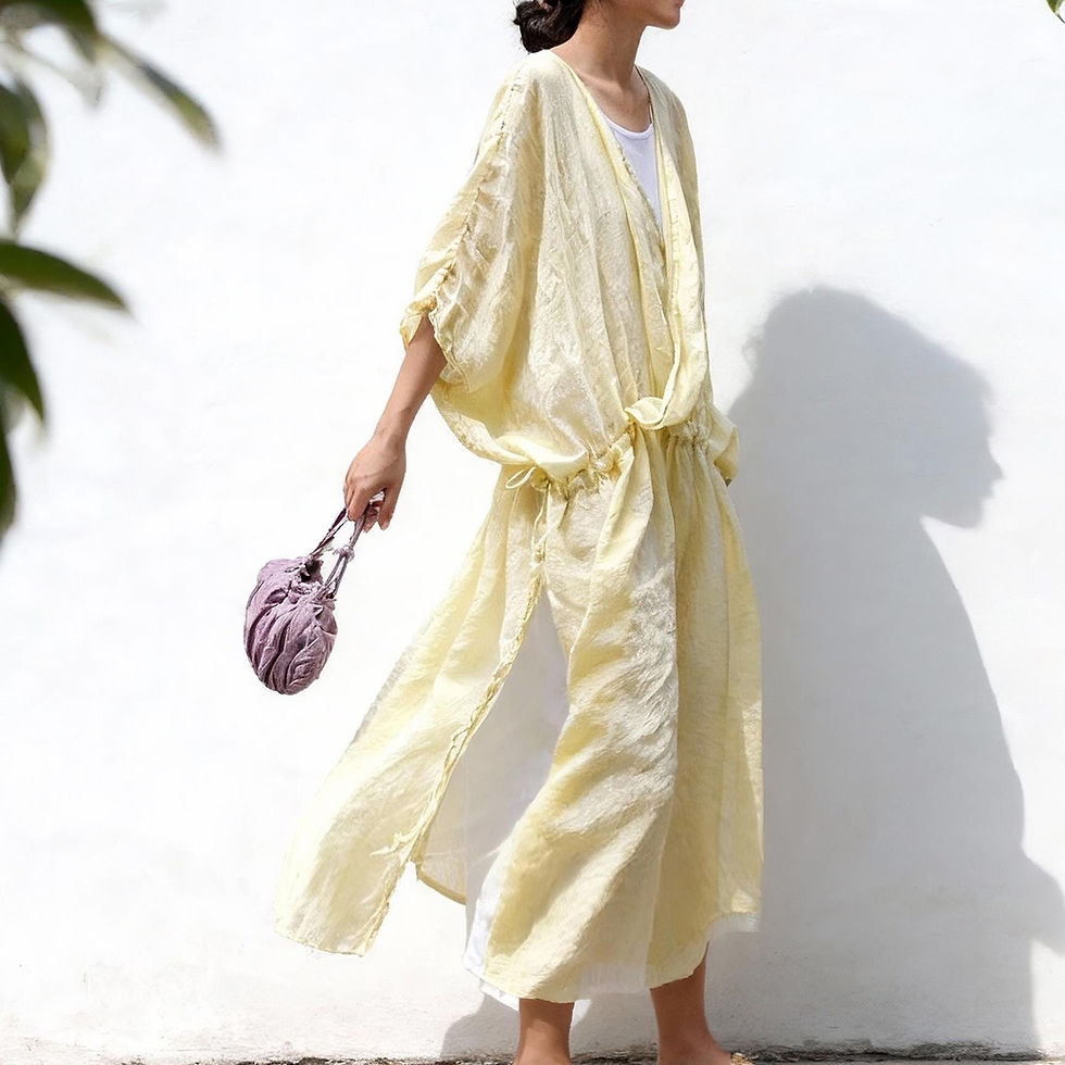 Model wearing pale yellow 100% ramie ethereal sheer maxi dress with waist tie