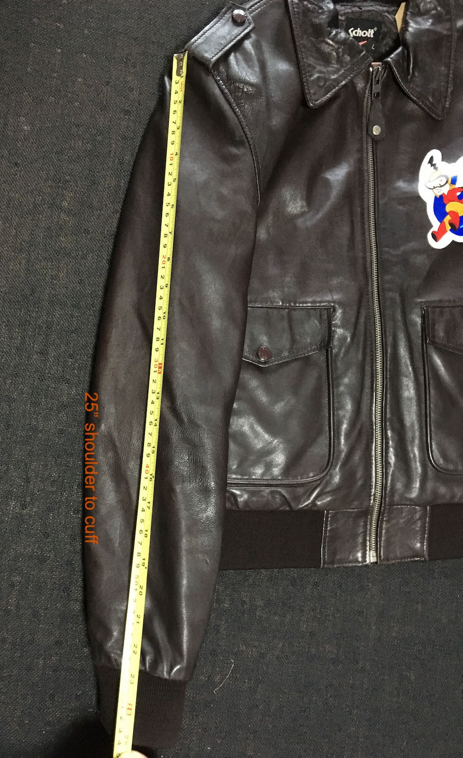 Thumbnail: Brown leather bomber jacket, measuring sleeve length