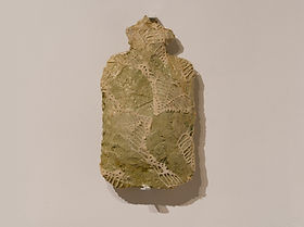 Concrete, textiles, varnish on a hot water bottle