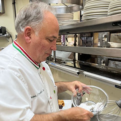 Chef Jasper Mirabile Jr. standing inside Jasper’s Italian Restaurant in Kansas City, smiling warmly, representing his family’s Sicilian cannoli tradition and decades-long culinary legacy.