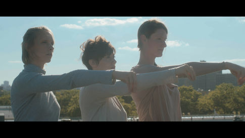 A Trio of dancers standing on a roof in Brooklyn. Photo Credit:: Blake Horn
