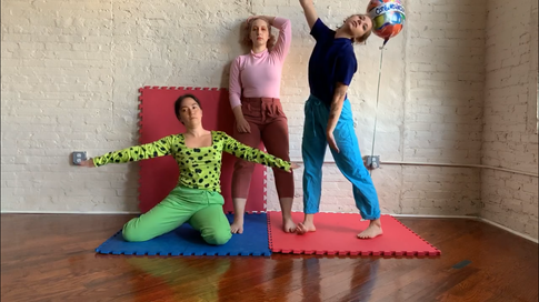 Three dancers stand in different poses on children's play mats. There is a mylar happy birthday balloon.