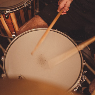 Person playing drums inside apartment