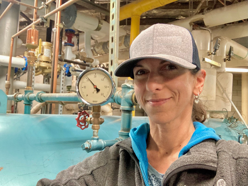 Karen stands in front the boiler which inspired her to write this piece.