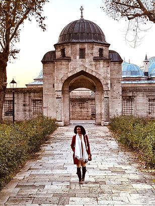 Woman walking in front of mosque in Istanbul