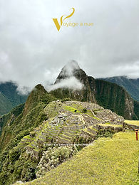 machu picchu in the background under cloudy skies
