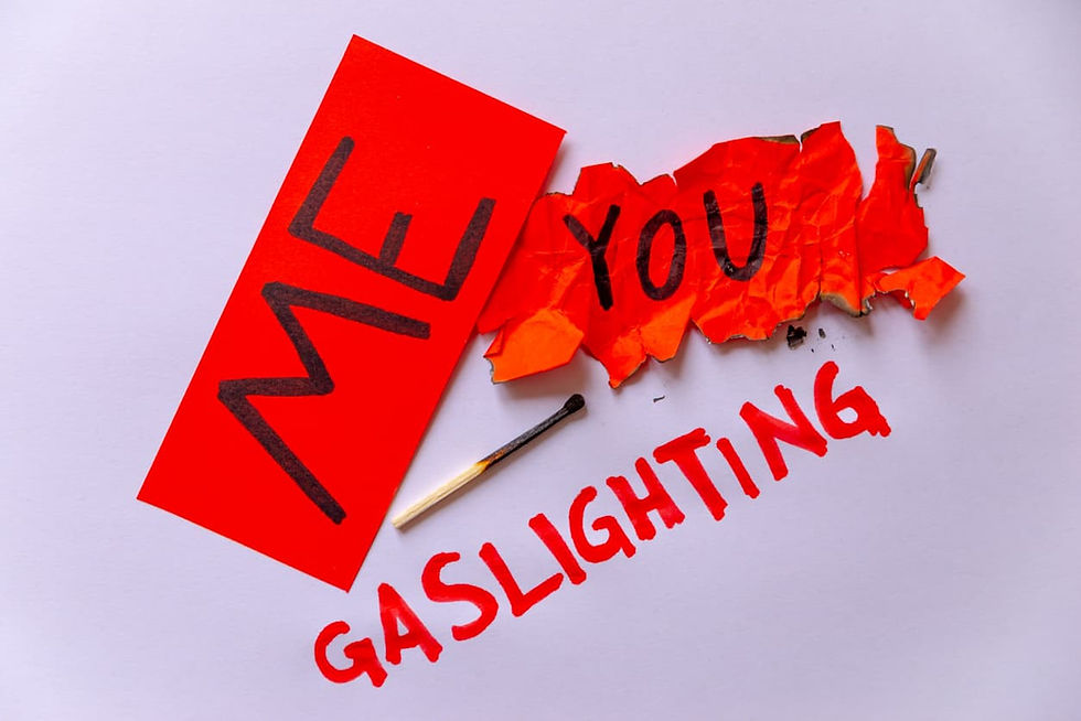 The words “me” and “you” and “gaslighting” appear on a background along with a lit match