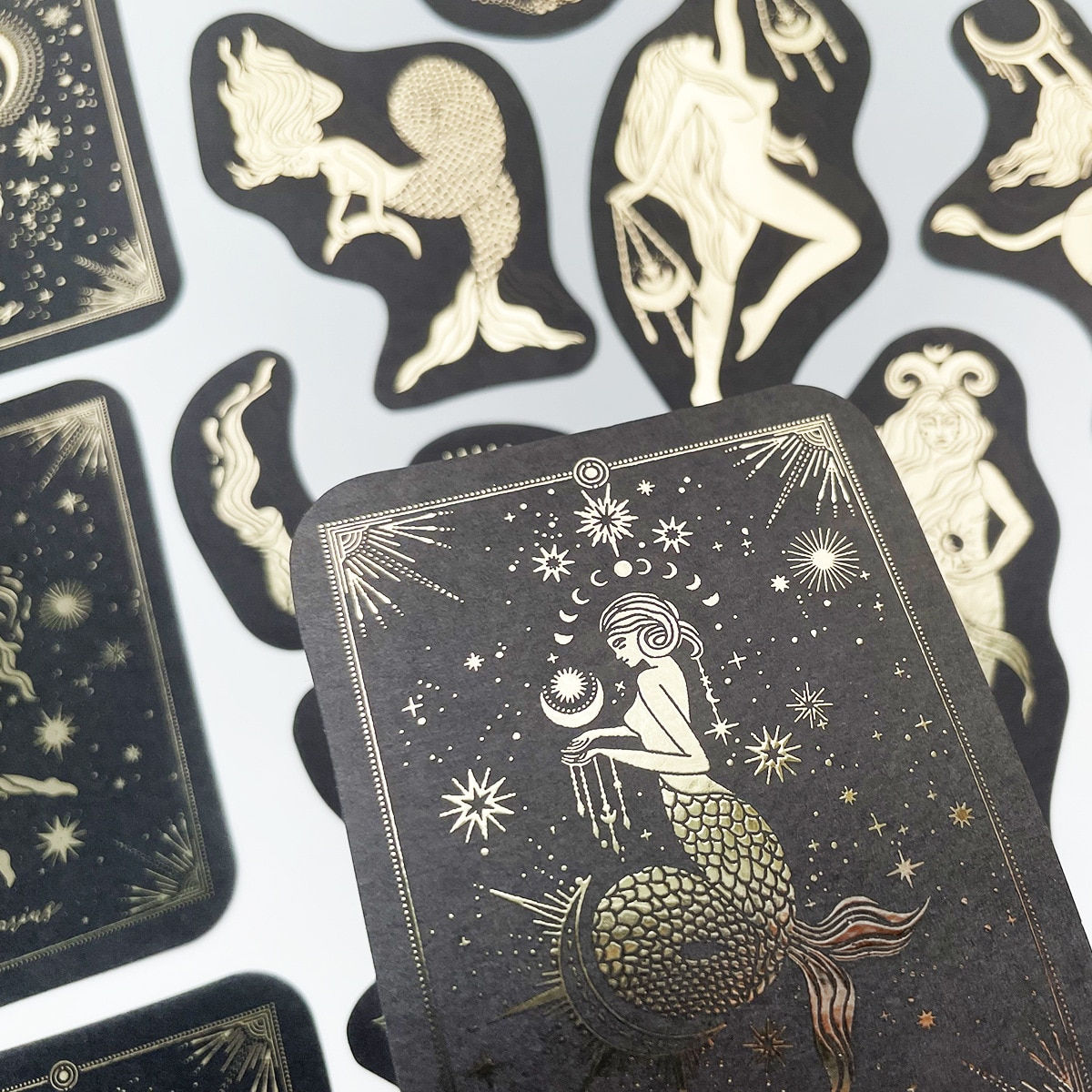 Tarot cards featuring gold foil constellations.