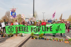 Protesters carrying a banner "rebel for life"