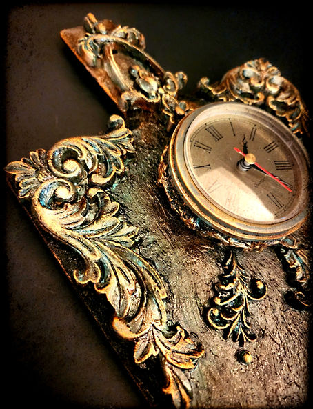 "Cutting Time"~ is a functional art piece with a dramatic feeling of baroque vintage, created with a wooden cutting board! The perfectly working clock piece is from a vintage 1970s mantel clock secured within a designed base. The beautiful beveled wooden cutting board has been texturized with many mediums, as acrylics, mica powders, inks, and gilded waxes were used to give such deep rich color and textures! Created out of wood, molding clay, and more! This is the perfect piece for any kitchen or dining area! The mounting assemblage is already attached!

To quickly change the battery, all that is needed is for you to pull the clock from the base (secured with simple velcro so that replacing the clock is just as easy!)

Dimensions: 14 x3 x 9