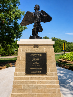Bronze Angel of Hope memorial statue on a stone pedestal