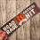 Thumbnail: Gray, Orange, and White bumper sticker with a 20 sided die in the center