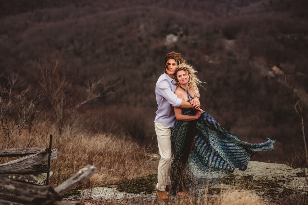 Couple embracing in a windy outdoor setting.