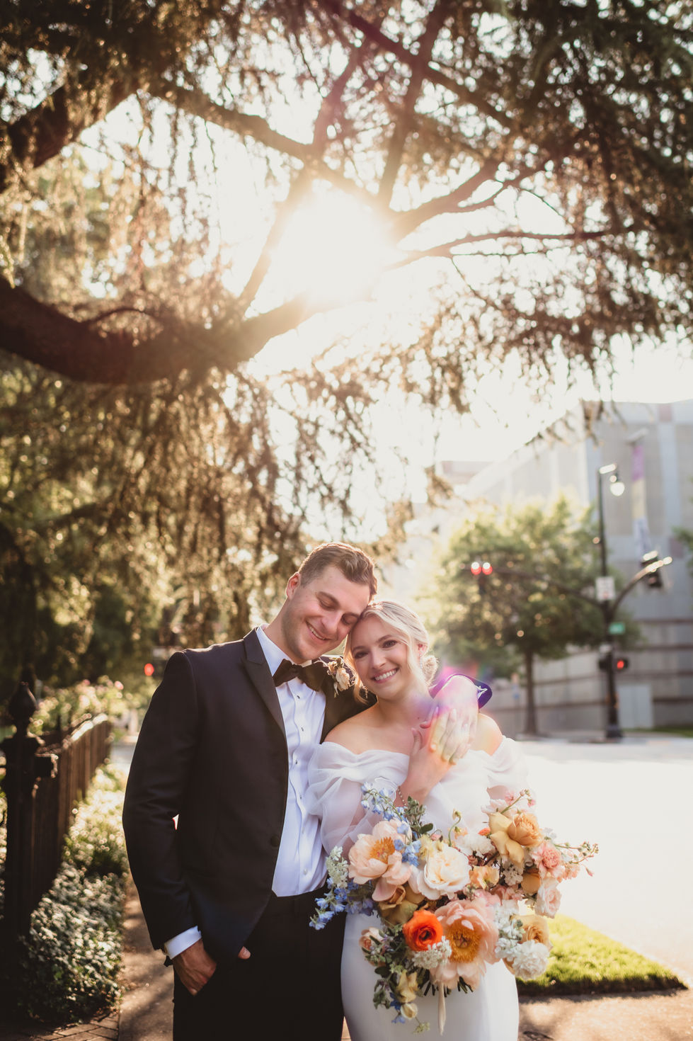 a bride and groom portrait with downtown in the background