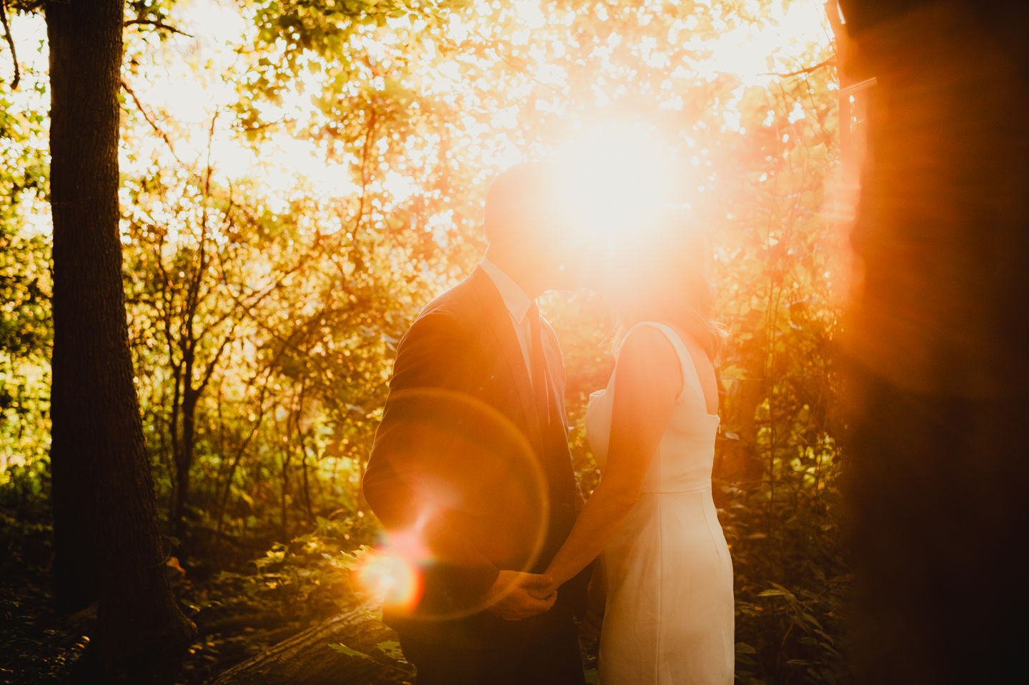 sunlight bursting through a wedding day kiss