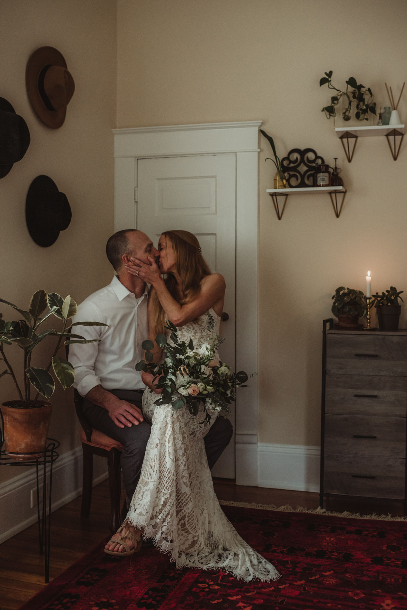 a couple kissing in a secluded corner on their wedding day