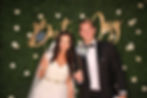 Photo booth with green hedge backdrop