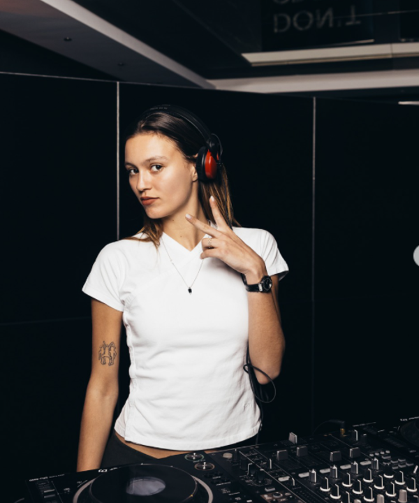 Paloma Le Friant DJ wearing headphones and a Hublot watch at a DJ deck
