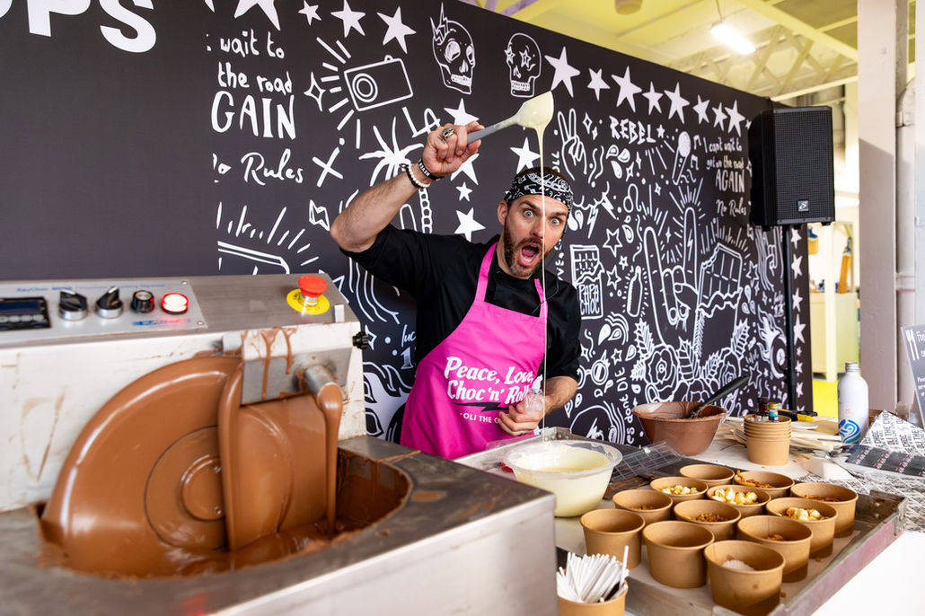 Chocolatier Oli The Choc leading a chocolate workshop during the Ideal Home Show 2026 at Olympia, London, photographed by London event photographer Harvey Aspell