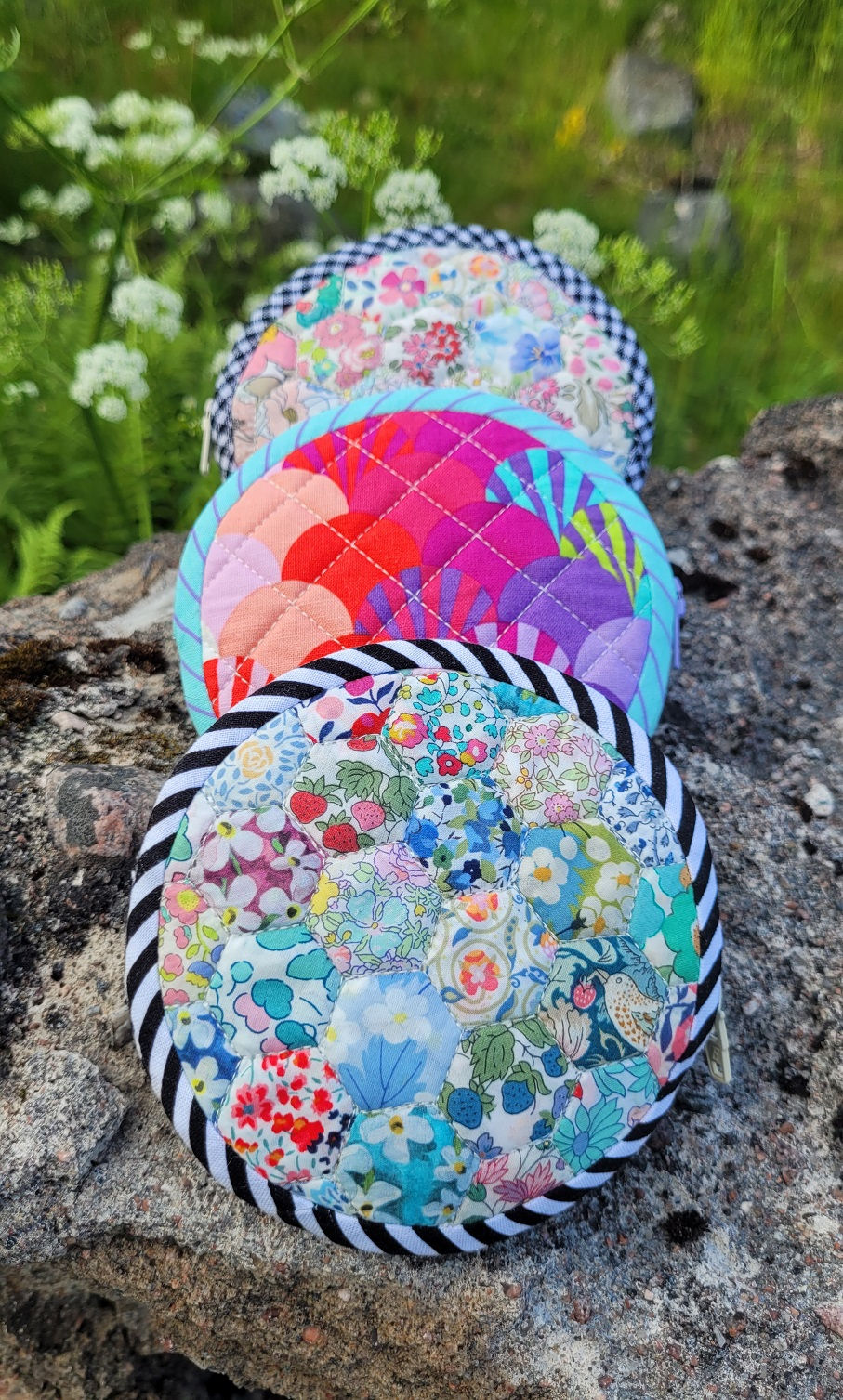 Thumbnail: Three samples of the Tiny Round Pouch sewing pattern in different fabrics.