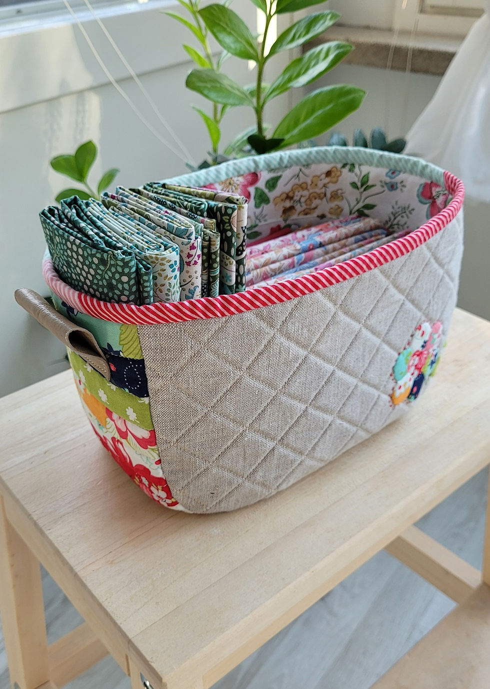 Thumbnail: Angled view of finished Winter mystery sewing basket filled with fabrics.