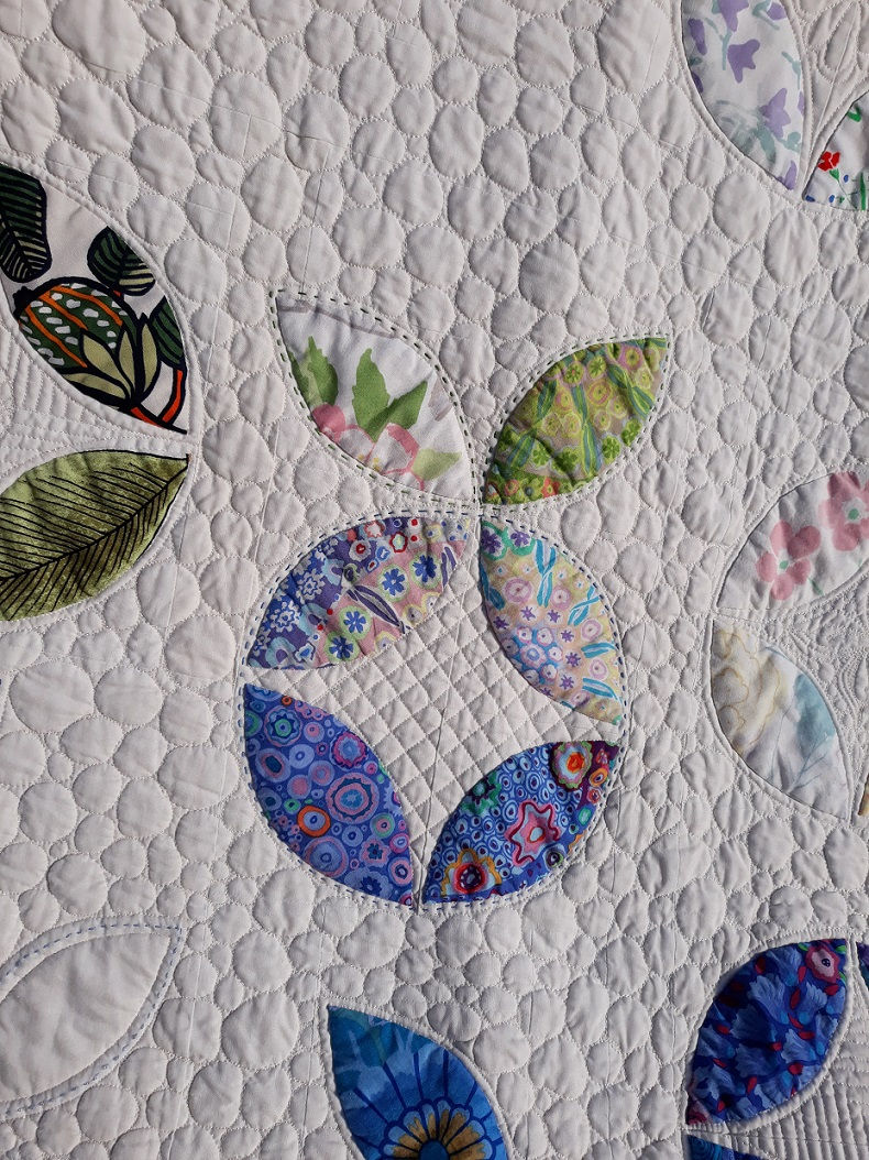 Thumbnail: Close-up of hand appliqué detail on colorful Marimekko and Kaffe Fassett fabrics