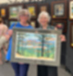 Laura Wilder and collector holding Mountain View at festival.