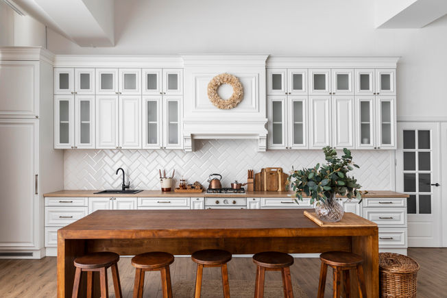 transitional kitchen with wood island dining