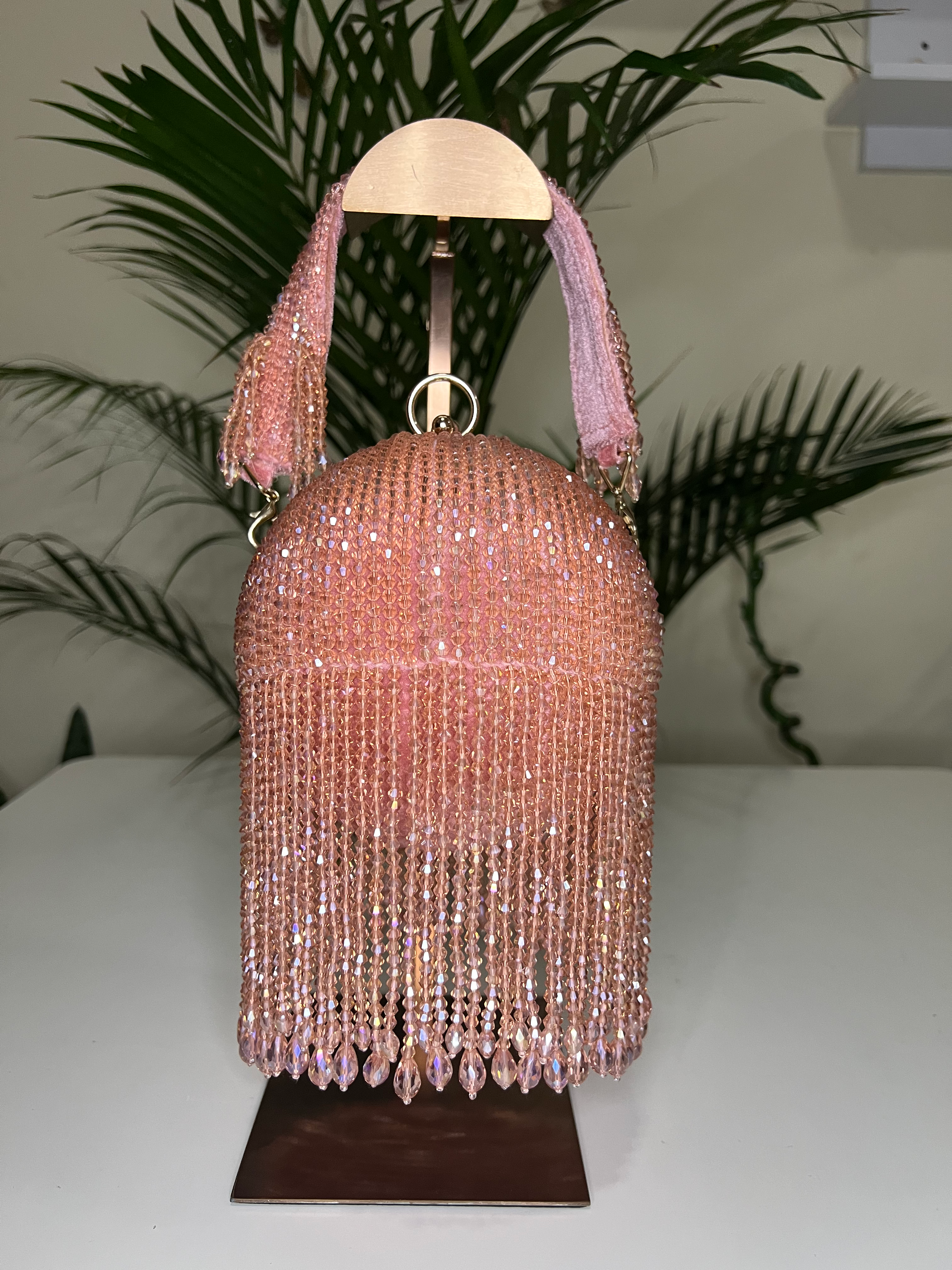 Unique round beaded purse in rose gold with dramatic long tassel fringe and velvet strap