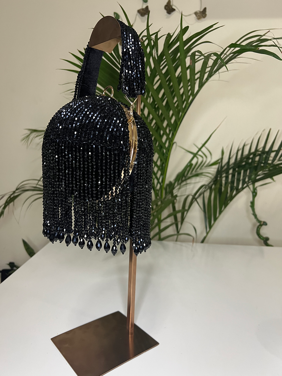 Women's dramatic black evening bag with a unique dome shape and beaded crystal tassel fringe
