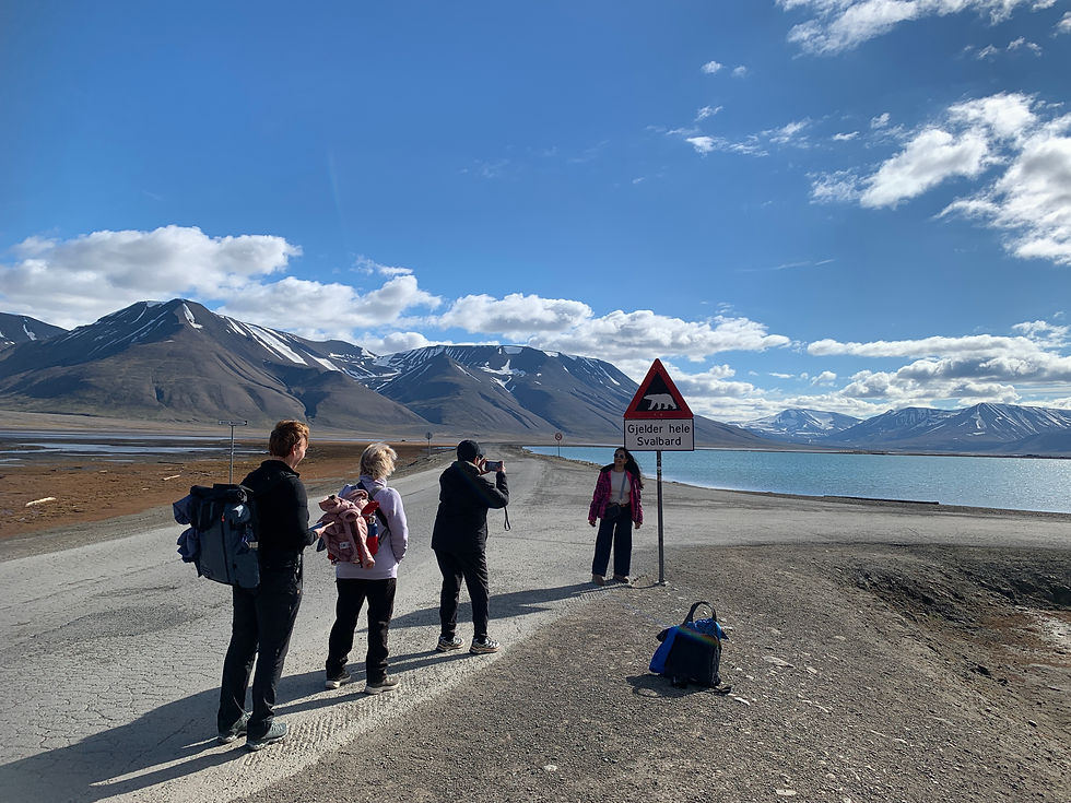 An Instagram moment - people lining up to take the photo of the polar bear sign in Longyearbyen, Svalbard