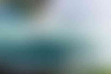 a boat with a rainbow in the background is going through a waterfall