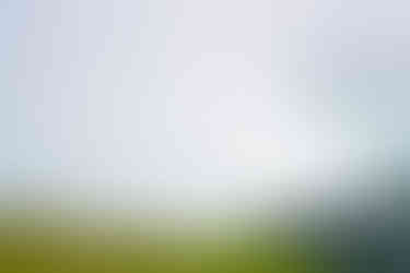 a waterfall is surrounded by a lush green hillside