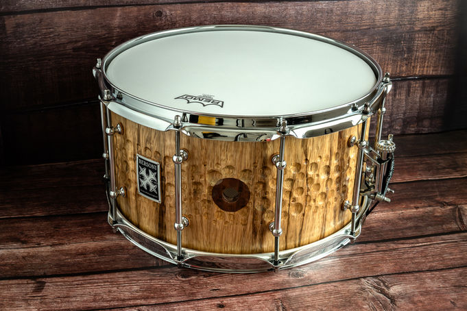 Badge view of textured Black Limba snare drum handmade by Bersoni Custom Drums with contrasting custom walnut air vent.
