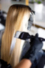 Hair stylist applying bleach using Framar Power Painter Color Brushes