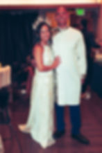 Armand and Tiffany in wedding attire at their gallery.