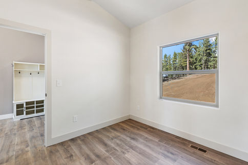 Interior of modern mountain home with wood accents, open concept, and mountain views.