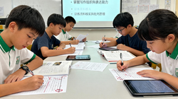 jimeng-2025-11-25-9341-香港小學生在課室內參加「校園編輯部課程」的寫作與編輯環節,多名學生坐在同一張桌子...