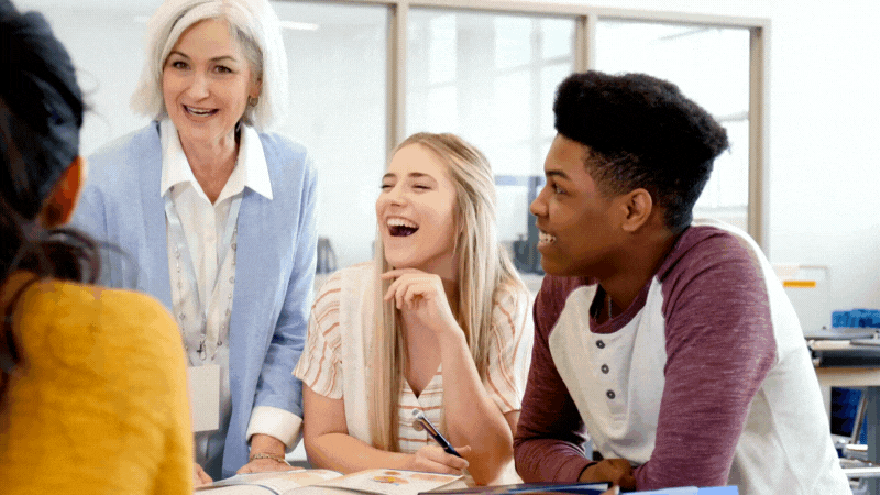 Students and teacher happily chatting