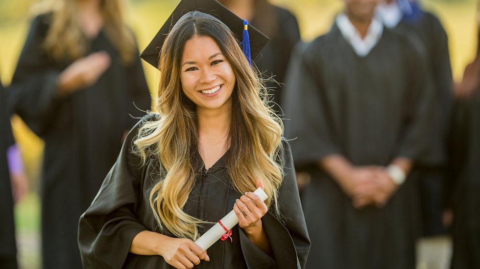female student holding her diploma at her graduation