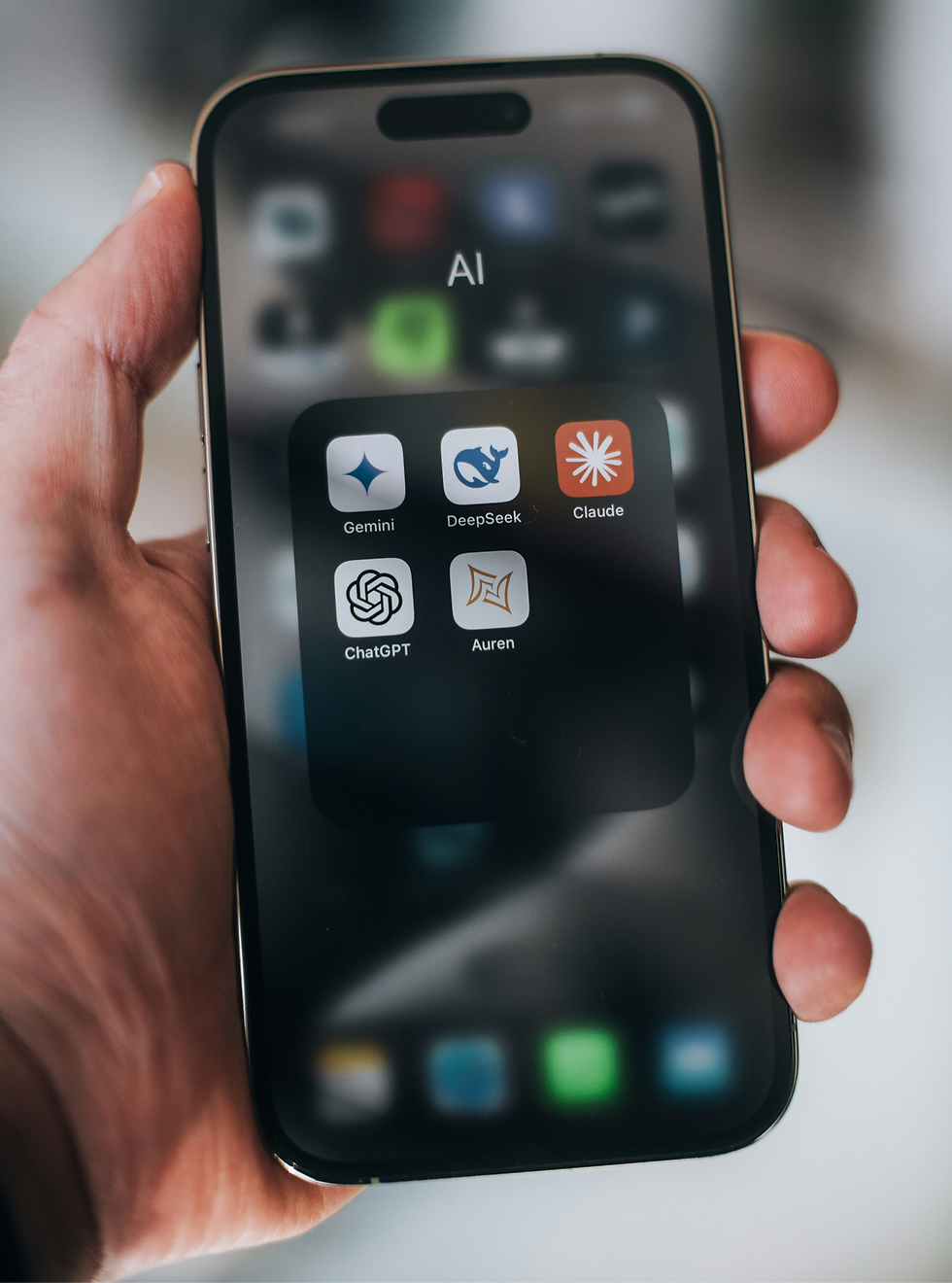 Mobile phone showing top AI search tools including ChatGPT, Gemini, Claude, and DeepSeek—used for business discovery and local search.