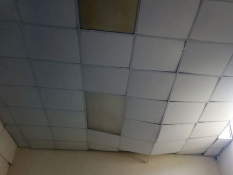 Suspended ceiling failure caused by overloaded ceiling grid and damaged hangers