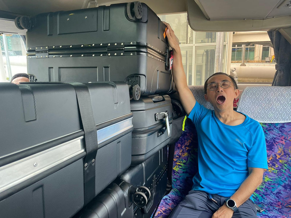 Tour participant sleeping near a pile of brompton travel hard cases